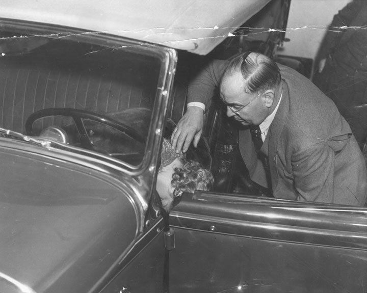 Captain Bert Wallis of the police homicide squad checks position of Thelma Todd's body. The coroner's report said her death was caused by carbon monoxide poisoning, but doubt remained.jpg
